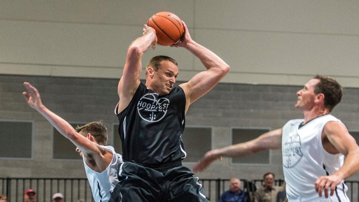 Casey Calvary grabs a rebound during last month’s Gonzaga alumni game at the Spokane Convention Center. Calvary played professionally in Japan, France, Australia and Spain. He now runs a medical equipment company in Spokane. “Spokane’s a vortex” for ex-Zags, Calvary says.