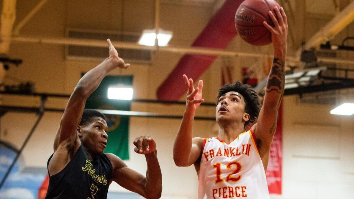 Franklin Pierce’s Claudell Quinland (12) goes up for a shot while defended by Micah Pollard (3) in the third quarter. Franklin Pierce High School played Foss High School in a basketball game at Franklin Pierce High School in Tacoma, Wash., on Friday, Jan. 4, 2019.