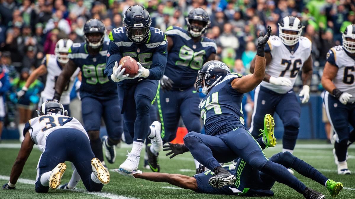 Seahawks defensive lineman Frank Clark (55) intercepts a pass in the first quarter. The Seattle Seahawks played the Los Angeles Rams in a NFL football game at CenturyLink Field in Seattle, Wash., on Sunday, Oct. 7, 2018.