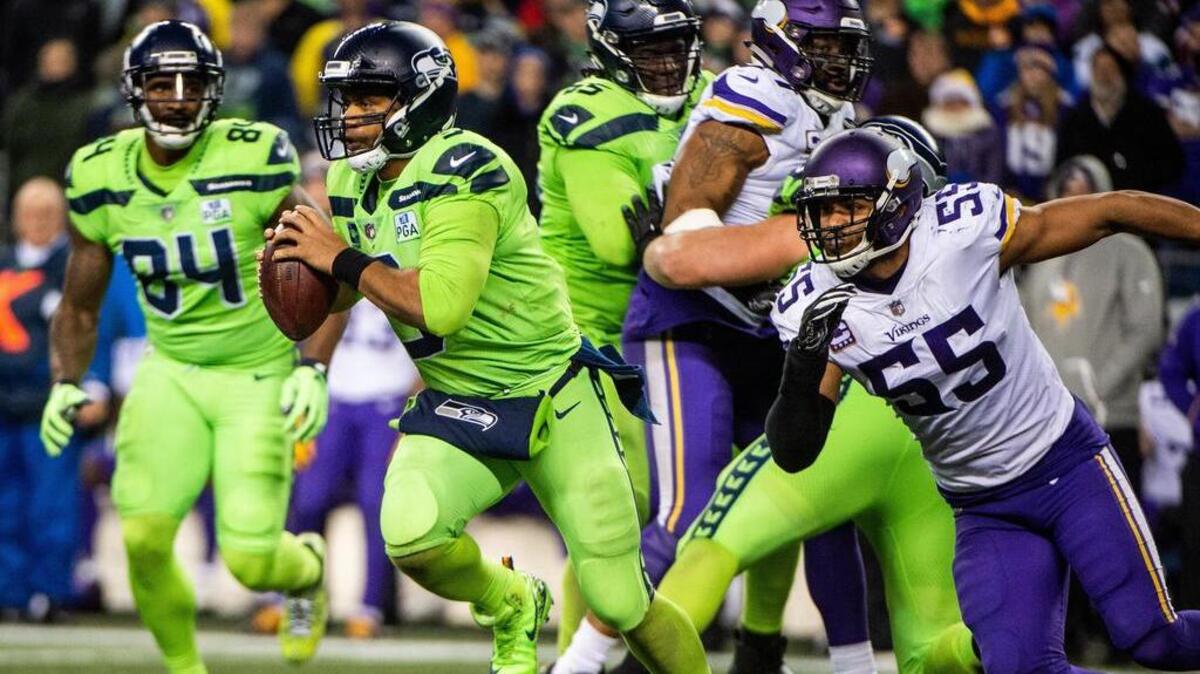 Seahawks quarterback Russell Wilson escapes pressure from Vikings linebacker Anthony Barr to break loose with a long run in the fourth quarter. The Seattle Seahawks played the Minnesota Vikings in a NFL football game at CenturyLink Field in Seattle, Wash., on Monday, Dec. 10, 2018.