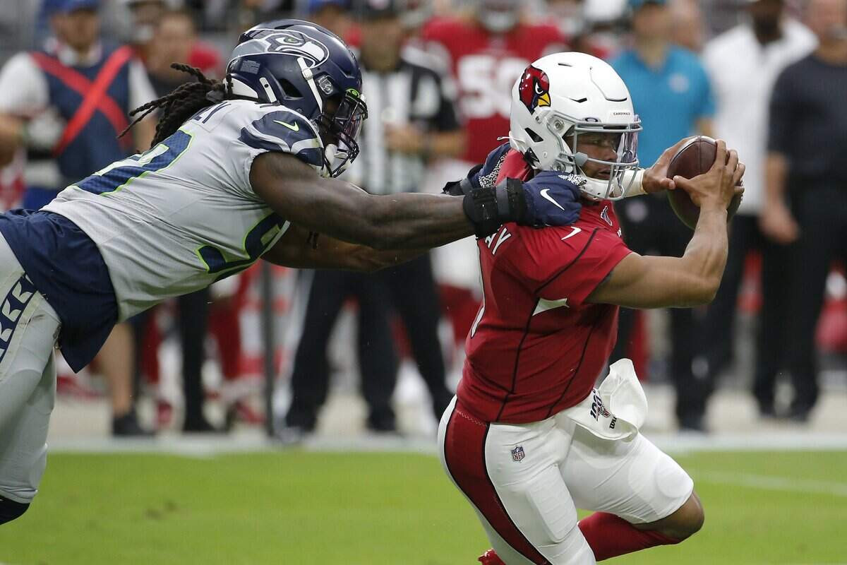 Arizona Cardinals quarterback Kyler Murray (1) eludes the reach of Seattle Seahawks outside linebacker Jadeveon Clowney (90) during the first half of an NFL football game, Sunday, Sept. 29, 2019, in Glendale, Ariz. (AP Photo/Rick Scuteri)