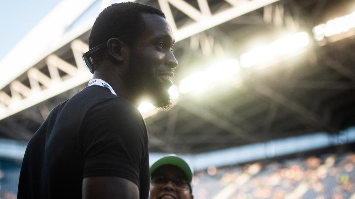 Kam Chancellor walks along the sideline before a Seahawks preseason game against the Indianapolis Colts on Aug. 9, 2018. He spent much of the 2018 season as a mentor for Seattle’s players while essentially retired because of a career-ending neck injury he sustained in a 2017 game.