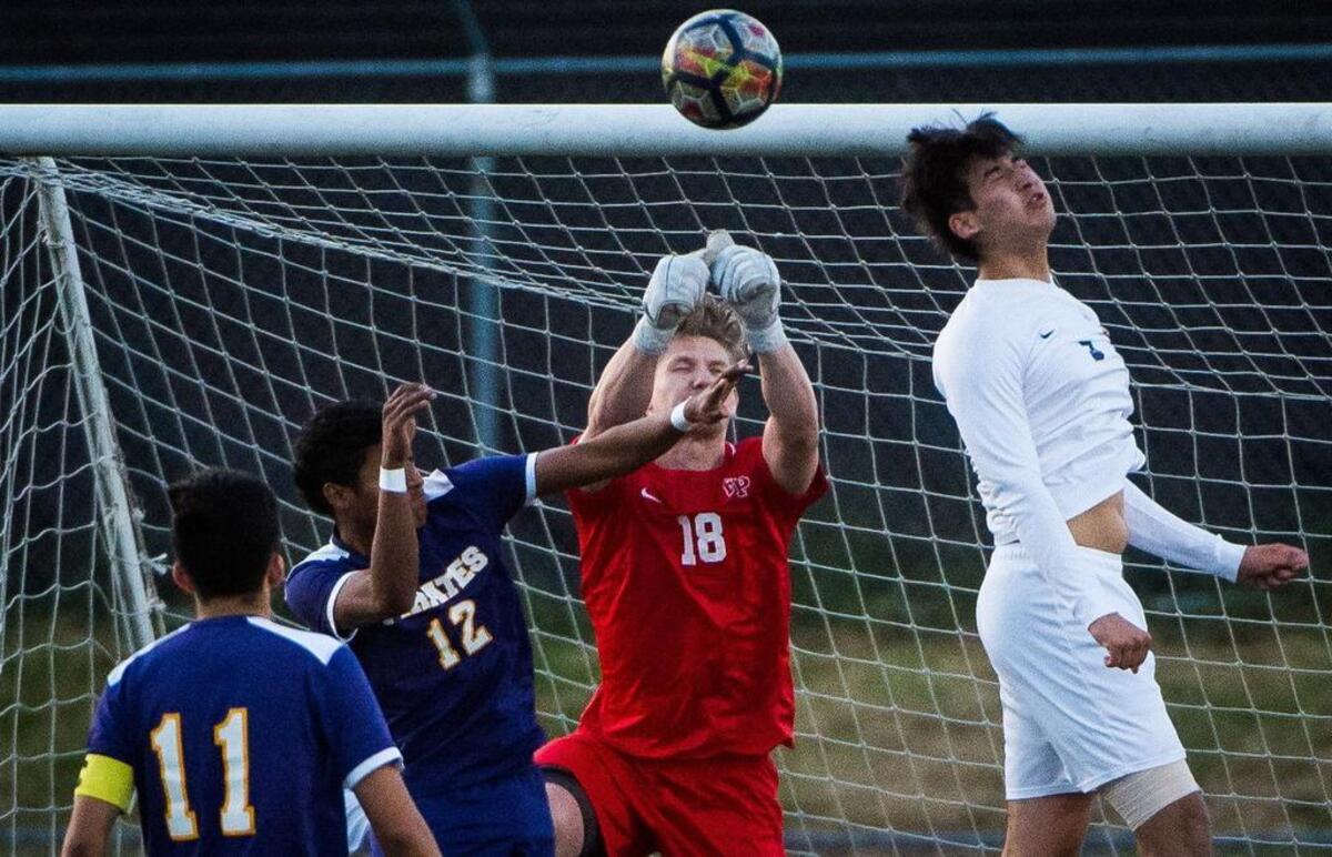 Franklin Pierce’s Noah Carver (18) punches away a late shot in the second half. Franklin Pierce played Highline in a soccer match at Franklin Pierce High School in Tacoma, Wash., on Saturday, May 12, 2018.
