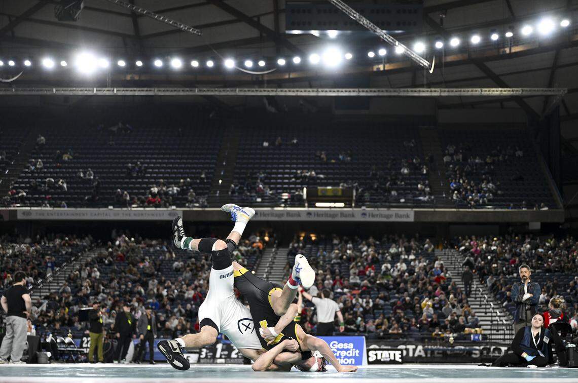 Tahoma’s Brycen Dawley and Gonzaga Prep’s Ryder Owen flip in the Boys 4A 126-pound Championship during the Mat Classic XXXVII at the Tacoma Dome, on Friday, Feb. 20, 2026, in Tacoma, Wash.