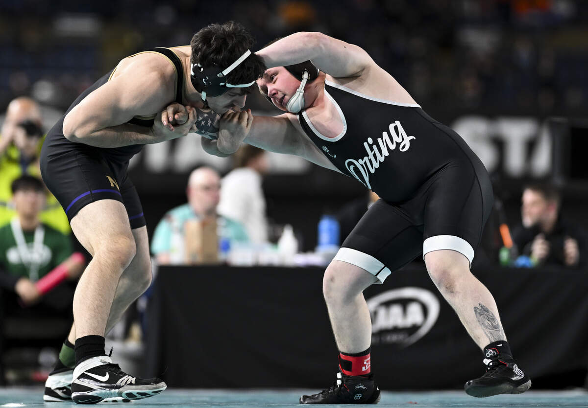 Orting’s Amos Voss and North Kitsap’s Luan Bekteshi lock up in the Boys 2A 175-pound Championship match during the Mat Classic XXXVII at the Tacoma Dome, on Saturday, Feb. 21, 2026, in Tacoma, Wash.
