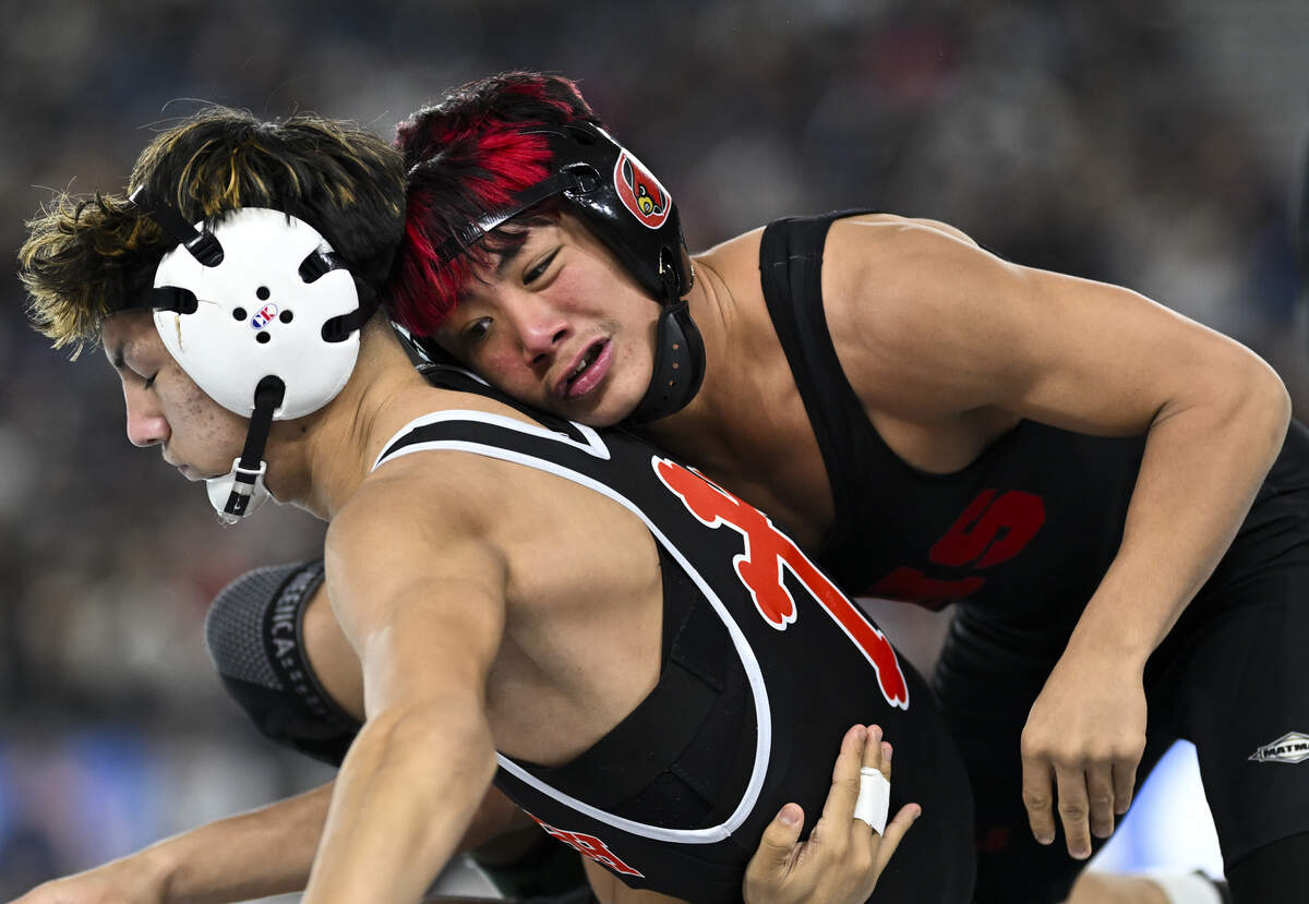 Orting’s Arcadius Cruz takes the back of Toppenish’s Audon Clark in the Boys 2A 120-pound Championship match during the Mat Classic XXXVII at the Tacoma Dome, on Saturday, Feb. 21, 2026, in Tacoma, Wash.