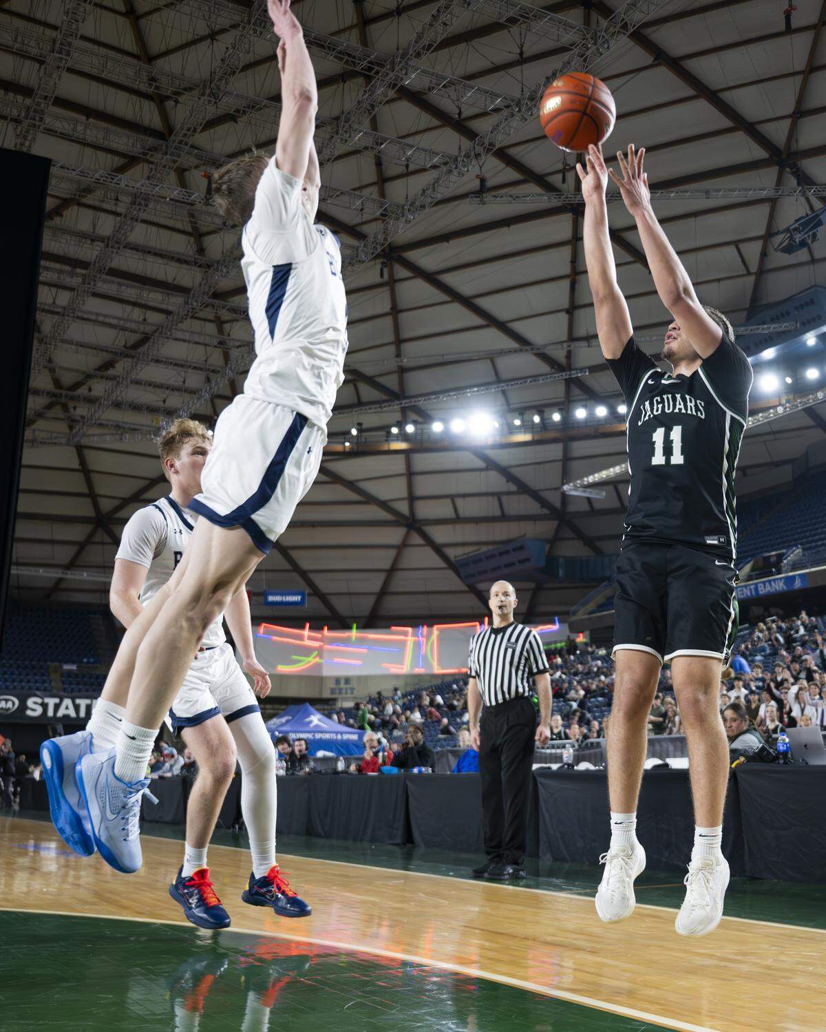 Emerald Ridge guard Mychal Turner (11) drains a three point basket against Gonzaga Prep during the semifinal round of the 4A State Tournament at the Tacoma Dome, on Friday, March 6, 2026, in Tacoma, Wash.