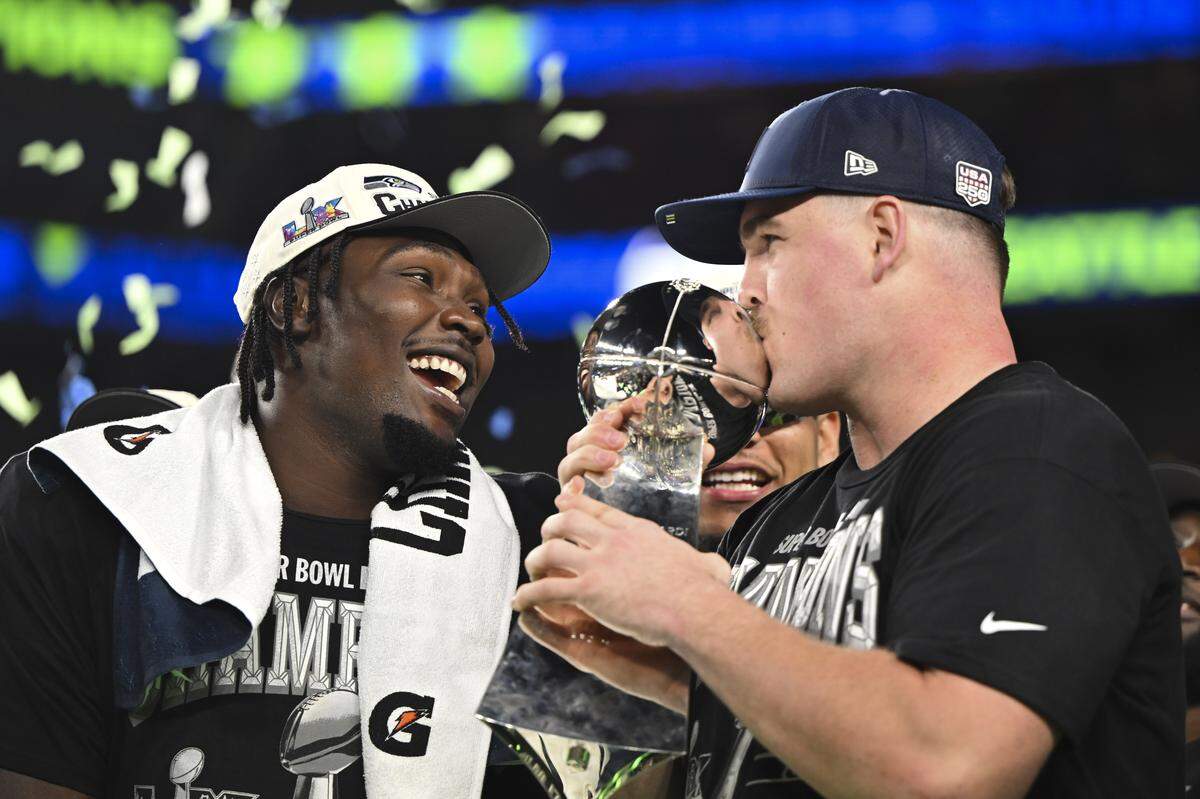 Seattle Seahawks guard Grey Zabel (76) kisses the Lombardi Trophy after beating the New England Patriots 29-13 in Super Bowl LX at Levi's Stadium on Sunday, Feb. 8, 2026, in Santa Clara, Calif.