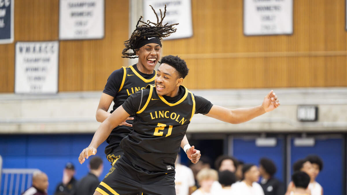 Lincoln forward Jaymari Byrd (21) and Lincoln guard Davion Shareef-Dulanacy (3) celebrate their win against O'Dea during the regional round of the 3A state basketball tournament at Bellevue College, on Saturday, Feb. 28, 2026, in Bellevue, Wash.