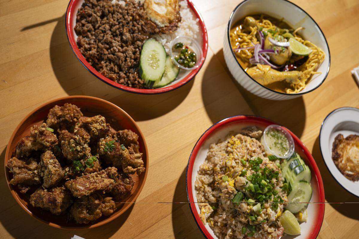 B Sitthichaisawad and Ashely Sripanya cooked at Freighthouse Square for five years before moving into their own storefront in Tacoma’s Lincoln District. Their mantra of “everyday Thai food” means (clocwise from top) pad ka paow, khao soi (dine-in only), crab fried rice and garlic pork ribs.