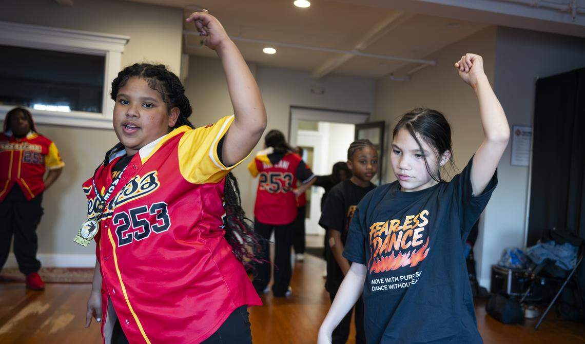 Ka’Liyah “Leelee” Baird, left, instruct other dancers on choreography during Fearless Dance practice at The Tacoma Armory, on Tuesday, April 7, 2026, in Tacoma, Wash.