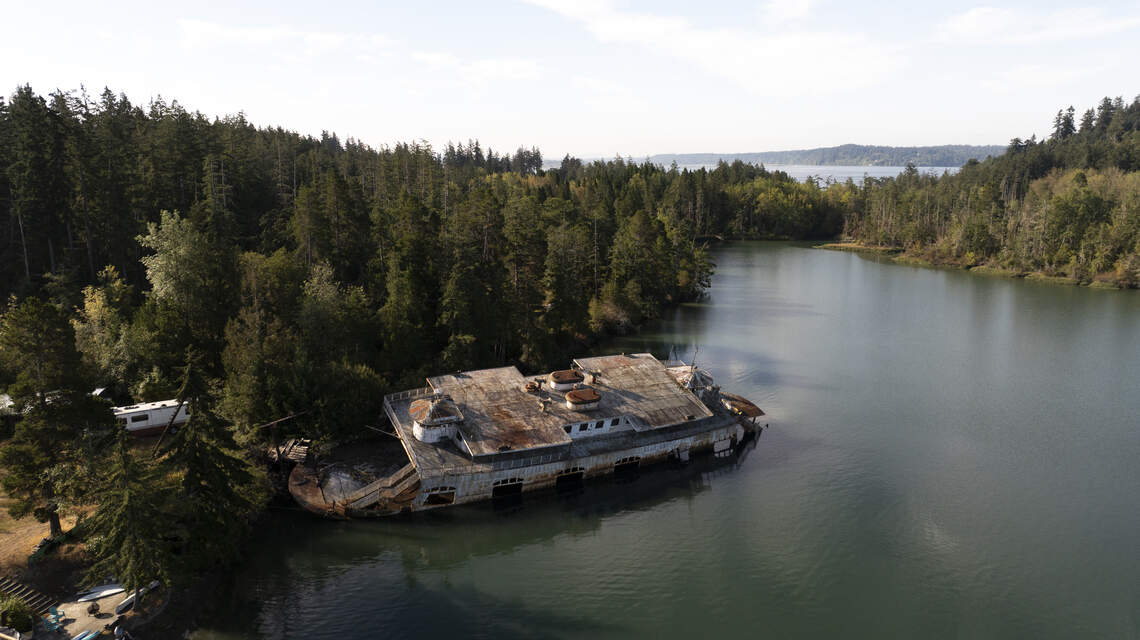 Century-old ferry slowly rusting on Anderson Island. How did it get there?