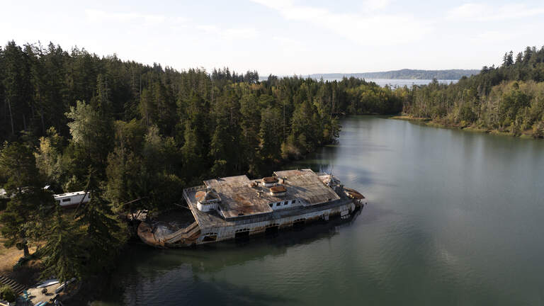 Century-old ferry slowly rusting on Anderson Island. How did it get there?
