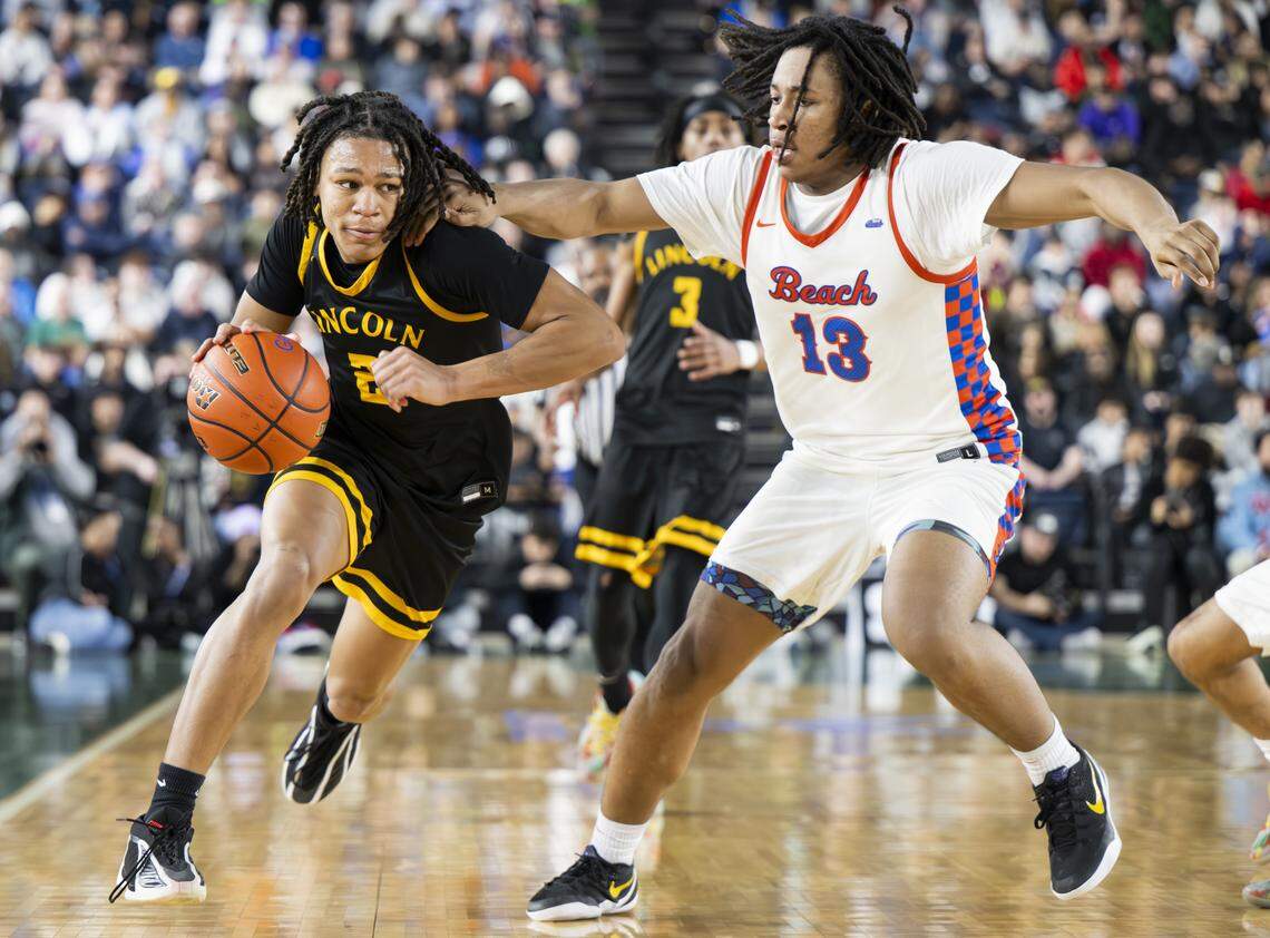 Lincoln forward Kasey Williams (2) brings the ball up court abasing Rainier Beach forward Wes Armstrong (13) during the Boys 3A State Tournament Championship at the Tacoma Dome, on Saturday, March 7, 2026, in Tacoma, Wash.