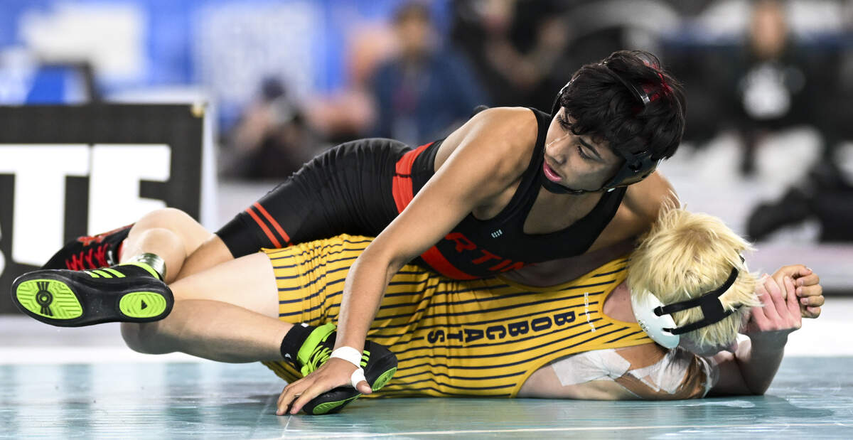 Orting’s Nery Rivas takes the back of Aberdeen’s Ryder Lessard in the Boys 2A 113-pound Championship match during the Mat Classic XXXVII at the Tacoma Dome, on Saturday, Feb. 21, 2026, in Tacoma, Wash.