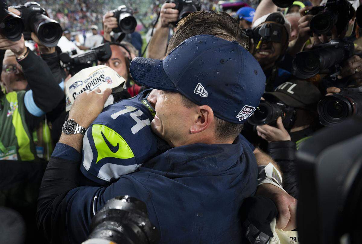 Seattle Seahawks head coach Mike MacDonald and Seattle Seahawks quarterback Sam Darnold (14) hug after beating the New England Patriots 29-13 in Super Bowl LX at Levi's Stadium on Sunday, Feb. 8, 2026, in Santa Clara, Calif.