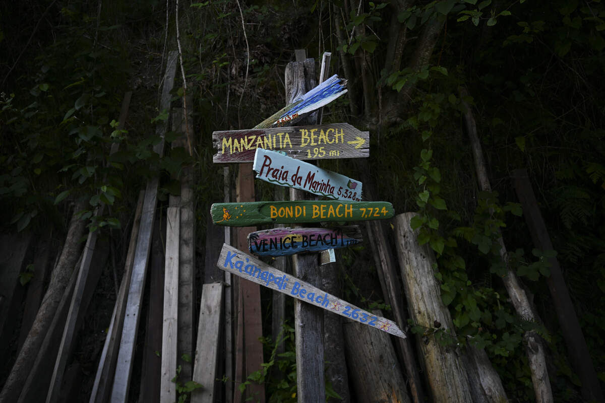 A sign denoting the distance to other beaches is seen on the walkway of the Salmon Beach community, on Wednesday, June 3, 2026, in Tacoma.