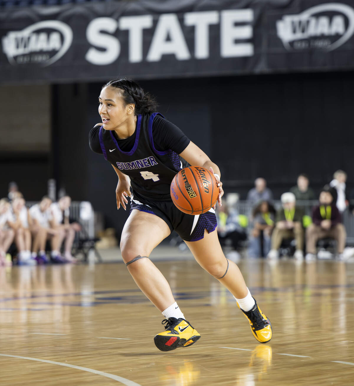 Sumner guard Kawehi Borden (4) brings the ball up court against Lake Washington during the semifinal round of the 4A State Tournament at the Tacoma Dome, on Friday, March 6, 2026, in Tacoma, Wash.