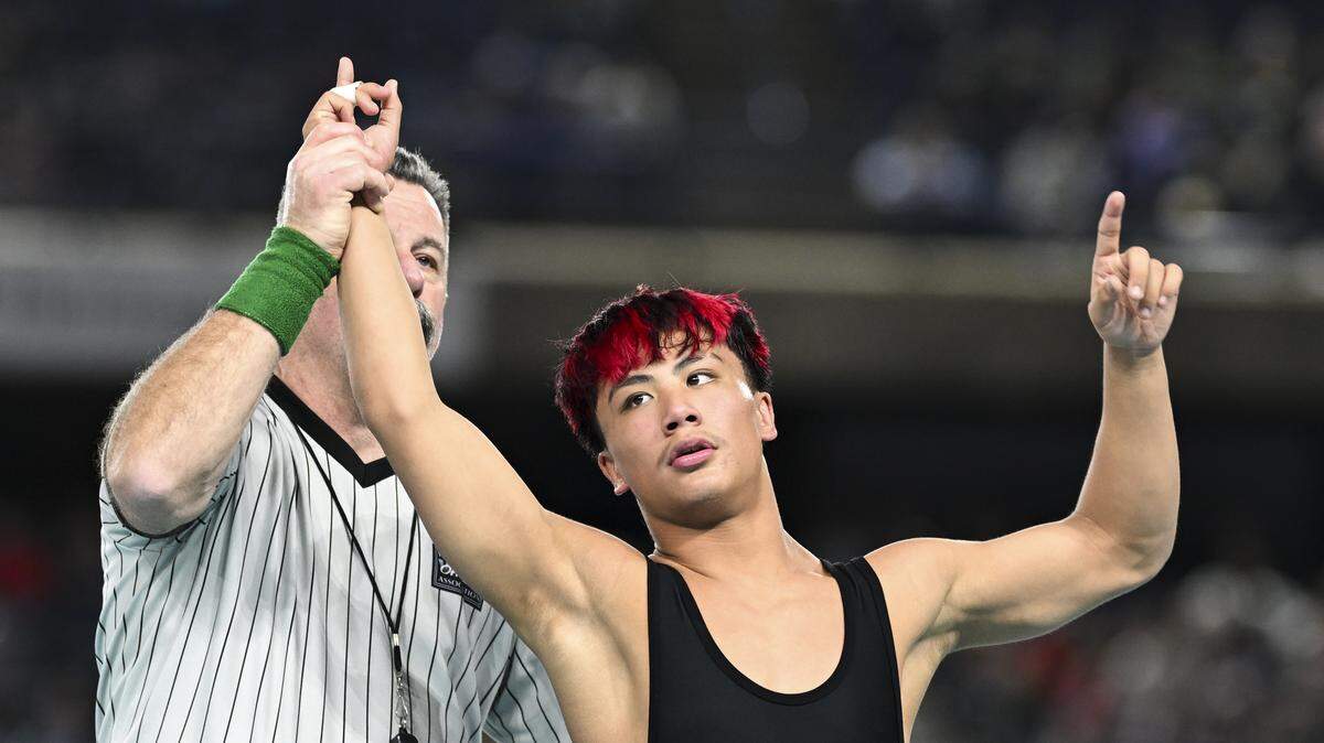 Orting’s Arcadius Cruz raise his hand after beating Toppenish’s Audon Clark in the Boys 2A 120-pound Championship match during the Mat Classic XXXVII at the Tacoma Dome, on Saturday, Feb. 21, 2026, in Tacoma, Wash.