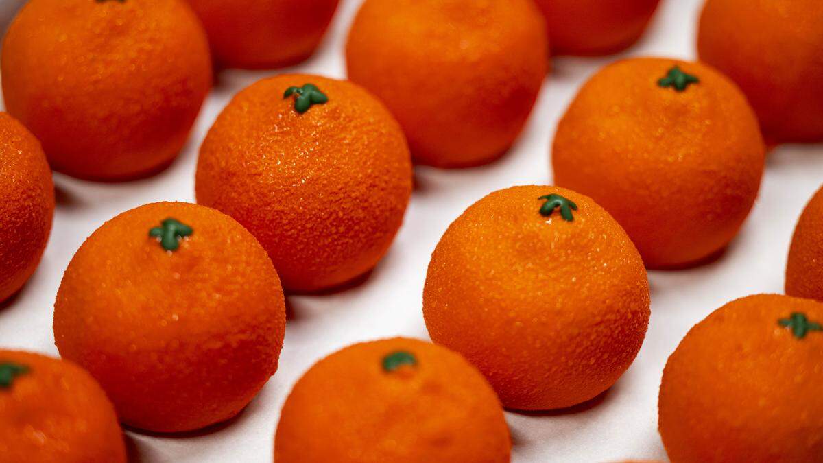 The oranges are cute and bulbous, finished with a texturizing cocoa-butter spritz and a dainty, green-dyed chocolate stem.