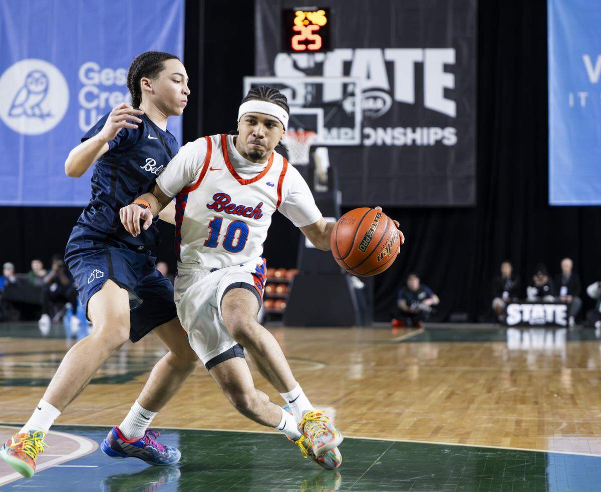 Rainier Beach guard Knowledge Wright (10) dribbles against Bellarmine Prep guard Ca’ron Dotson (2) during the semifinal round of the 3A State Tournament at the Tacoma Dome, on Friday, March 6, 2026, in Tacoma, Wash.