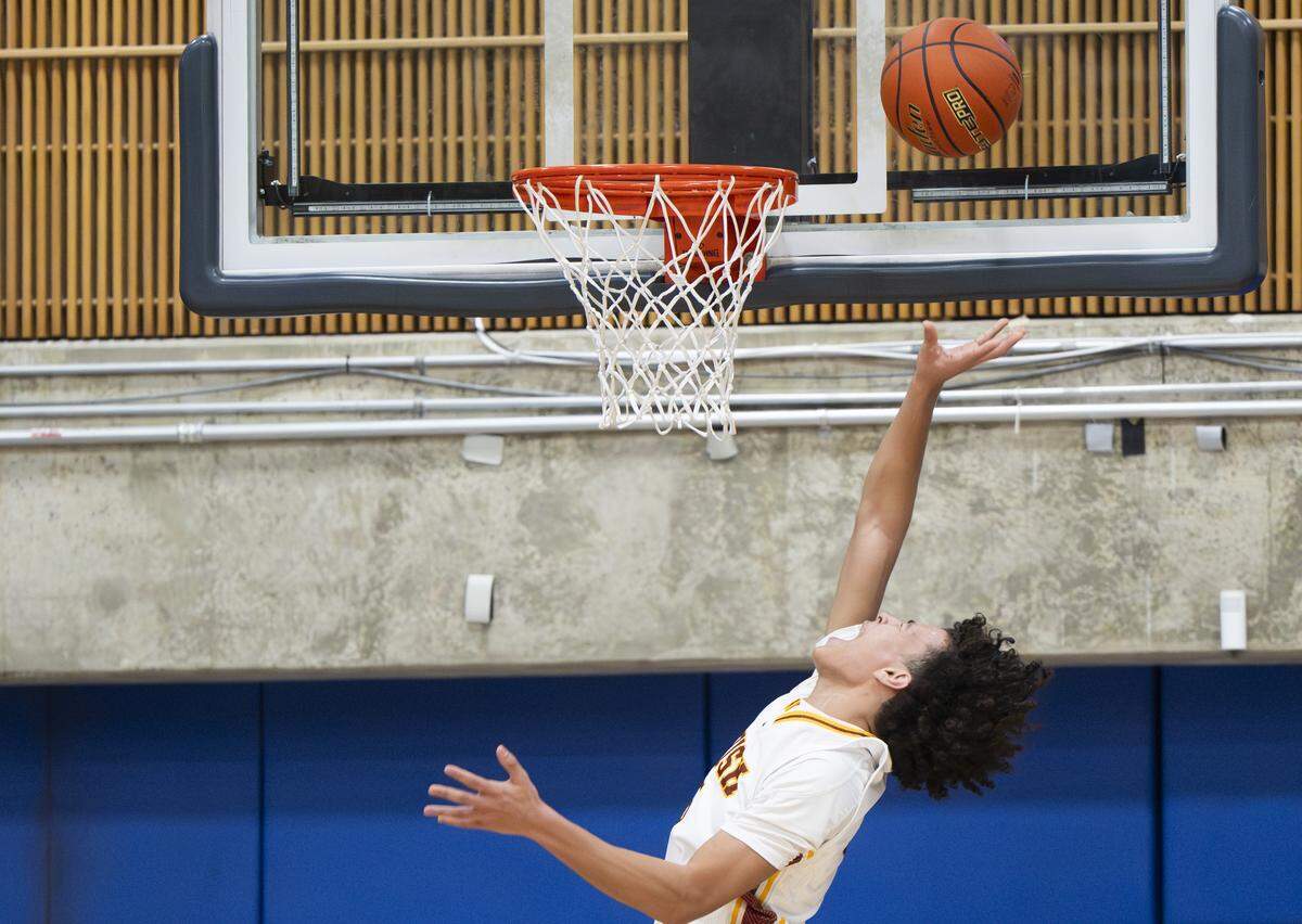 O'Dea guard Brian Webster (5) puts the rebound away against Lincoln during the regional round of the 3A state basketball tournament at Bellevue College, on Saturday, Feb. 28, 2026, in Bellevue, Wash.