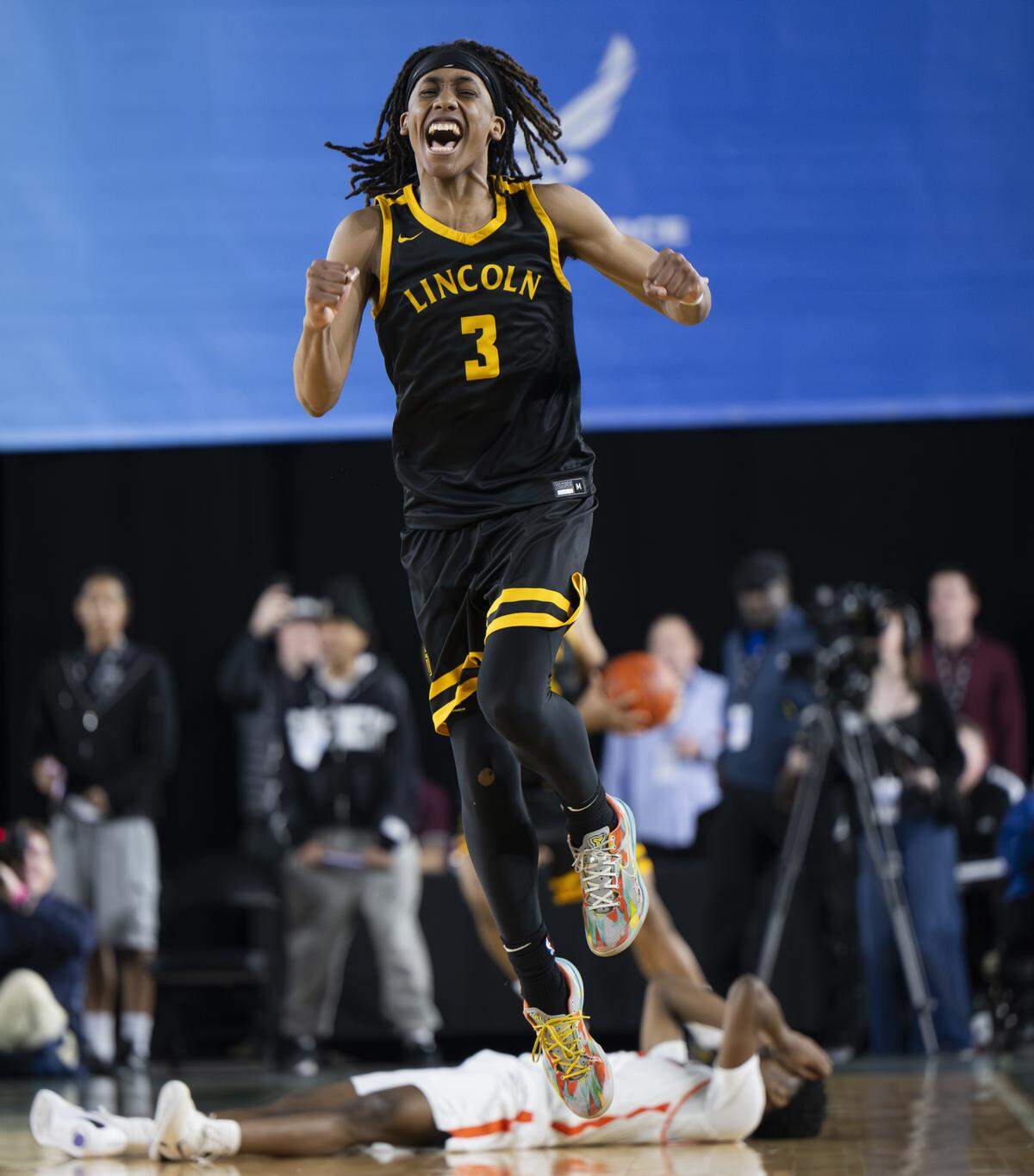 Lincoln guard Davion Shareef-Dulaney (3) reacts to beating Eastside Catholic during the semifinal round of the 3A State Tournament at the Tacoma Dome, on Friday, March 6, 2026, in Tacoma.