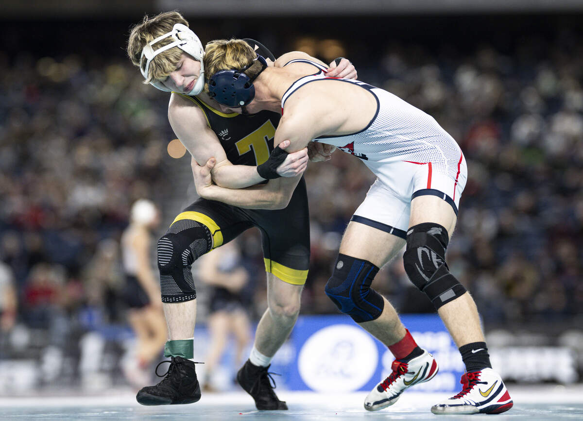 Tahoma’s Owen Marshall goes for the outside hip against Eisenhower’s Jarek Dobbie in the Boys 4A 132-pound Championship match during the Mat Classic XXXVII at the Tacoma Dome, on Friday, Feb. 20, 2026, in Tacoma, Wash.