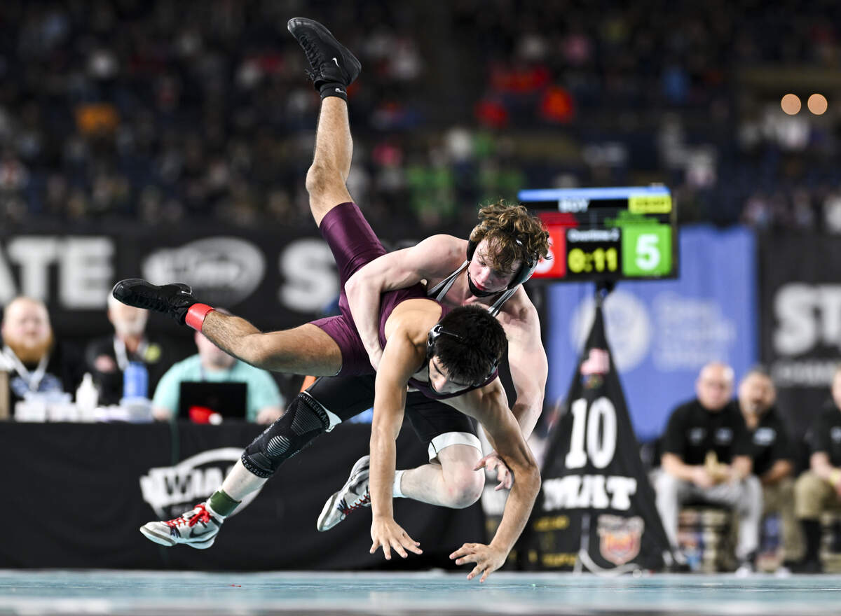 Orting’s Trevor Anderson takes down Toppenish’s Steve Romero in the Boys 2A 126-pound Championship match during the Mat Classic XXXVII at the Tacoma Dome, on Saturday, Feb. 21, 2026, in Tacoma, Wash.