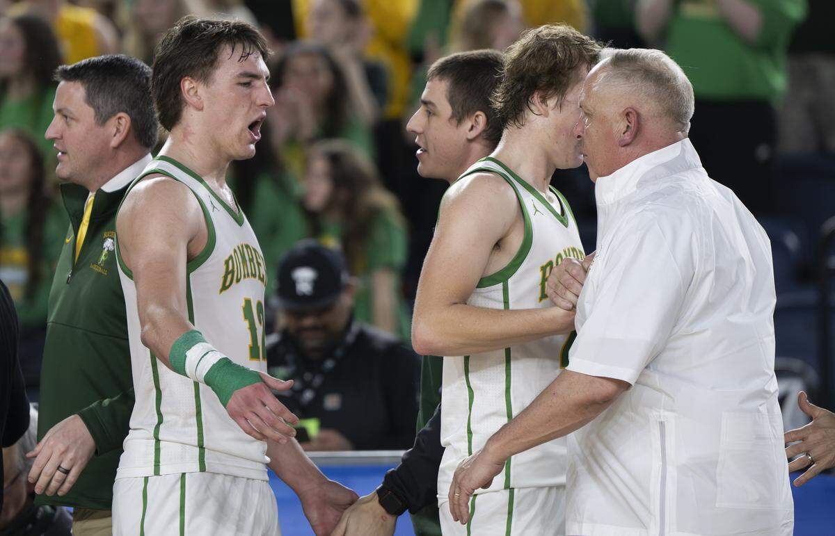 Richland guard Landen Northrop (12) and guard Jackson Woodard (22) come off the court in the closing second of their victory over Lake Washington in the semifinal round of the 4A State Tournament at the Tacoma Dome, on Friday, March 6, 2026, in Tacoma.