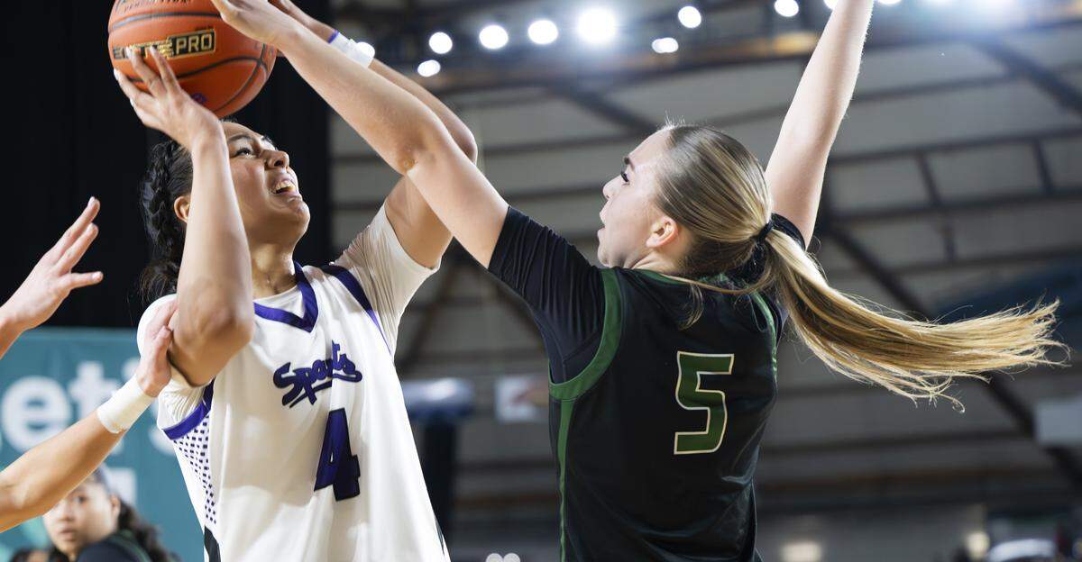 Sumner guard Kawehi Borden (4) is fouled by Auburn’s Morgan Richardson (5) during the first round of the 4A State Tournament at the Tacoma Dome, on Wednesday, March 4, 2026, in Tacoma, Wash.