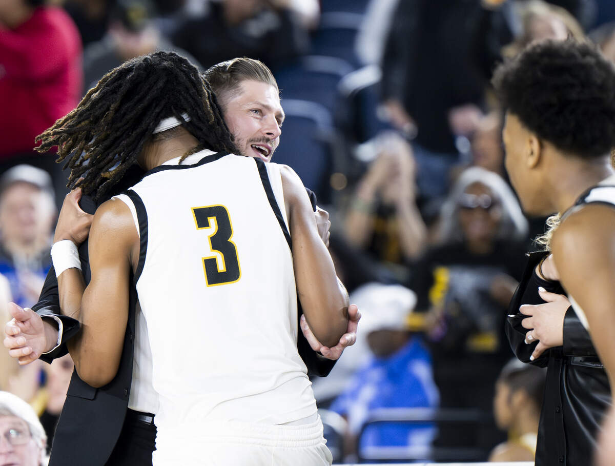 Lincoln guard Davion Shareef-Dulaney (3) and head coach Ryan Rogers hug after their victory against Bellevue during the quarterfinal round of the 3A State Tournament at the Tacoma Dome, on Thursday, March 5, 2026, in Tacoma, Wash.