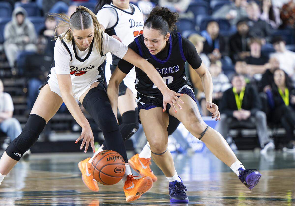 Davis guard Cheyenne Hull (13) steals the ball from Sumner guard Olivia Collins (10) during the Girls 4A State Tournament Championship at the Tacoma Dome, on Saturday, March 7, 2026, in Tacoma, Wash.