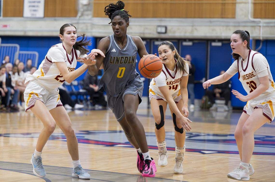 Lincoln forward Oliviyah Edward (0) drives against Lakeside guard Kate Ma (25) during the regional round of the 3A state basketball tournament at Bellevue College, on Saturday, Feb. 28, 2026, in Bellevue, Wash.