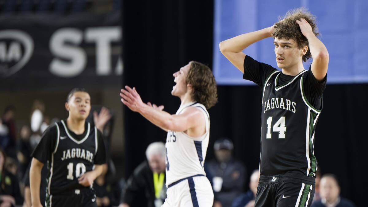 Emerald Ridge guard Ellis Mosley (14) reacts to their loss to Gonzaga Prep in the semifinal round of the 4A State Tournament at the Tacoma Dome, on Friday, March 6, 2026, in Tacoma, Wash.