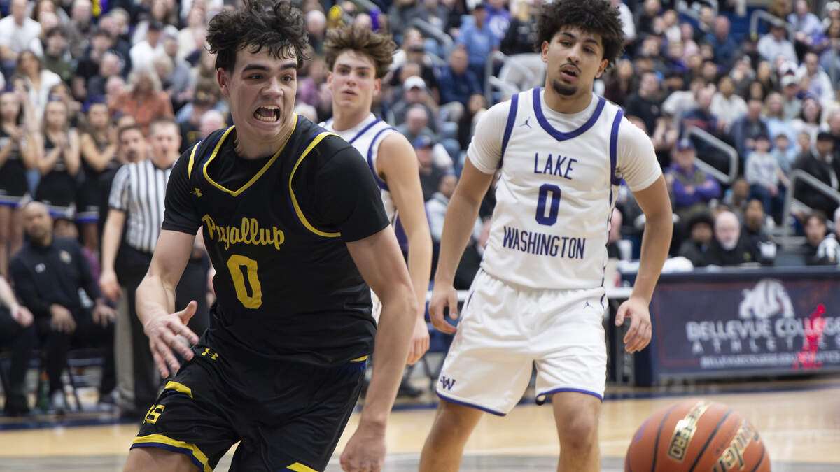 Puyallup post Mason Sonntag (0) goes for the ball against Lake Washington during the regional round of the 4A state basketball tournament at Bellevue College, on Saturday, Feb. 28, 2026, in Bellevue, Wash.