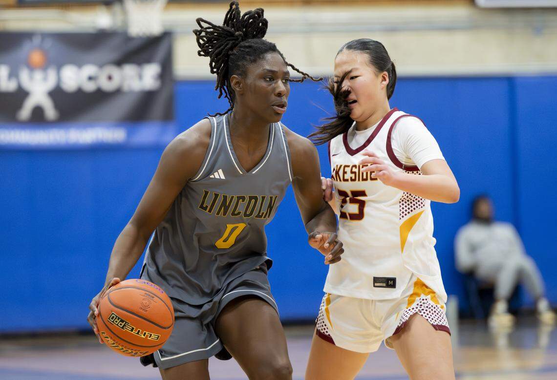 Lincoln forward Oliviyah Edward (0) is fouled by Lakeside guard Kate Ma (25) during the regional round of the 3A state basketball tournament at Bellevue College, on Saturday, Feb. 28, 2026, in Bellevue, Wash.