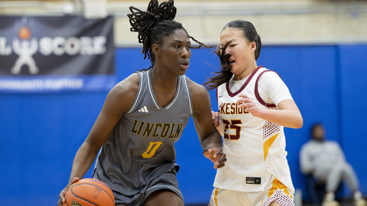 Lincoln forward Oliviyah Edward (0) is fouled by Lakeside guard Kate Ma (25) during the regional round of the 3A state basketball tournament at Bellevue College, on Saturday, Feb. 28, 2026, in Bellevue, Wash.