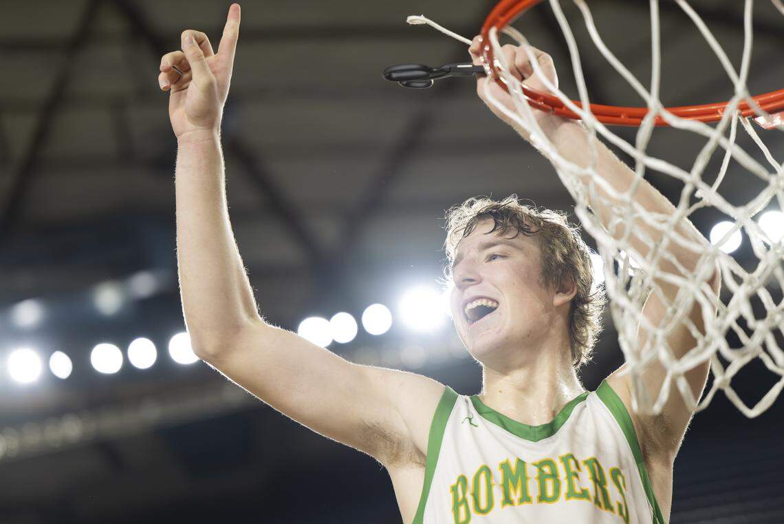 Richland guard Jackson Woodard (22) cuts down the nets altering beating Gonzaga Prep in the Boys 4A State Tournament Championship at the Tacoma Dome, on Saturday, March 7, 2026, in Tacoma, Wash.