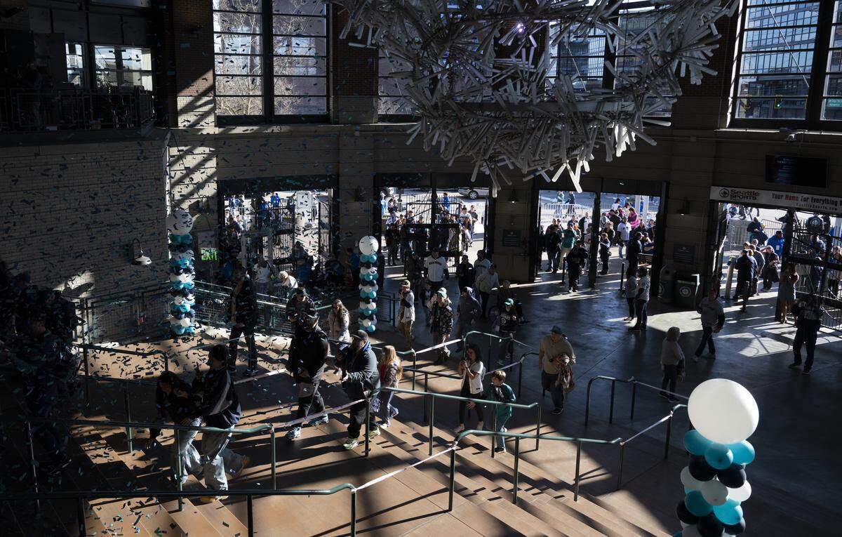 Mariners fans talking World Series for this season enter home-plate entrance on opening day at T-Mobile Park, on Thursday, March 26, 2026, in Seattle.