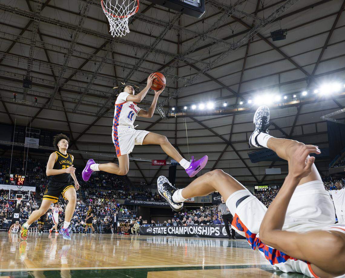 Rainier Beach guard JJ Crawford (11) picks up the put back against Lincoln during the Boys 3A State Tournament Championship at the Tacoma Dome, on Saturday, March 7, 2026, in Tacoma, Wash.