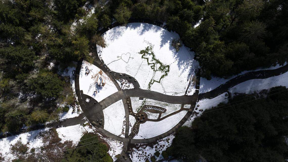 Designs carved into the snow in Sticks 'n' Stones Park after snow and wintry mix blanketed Bonney Lake overnight, on Thursday, April 16, 2026.