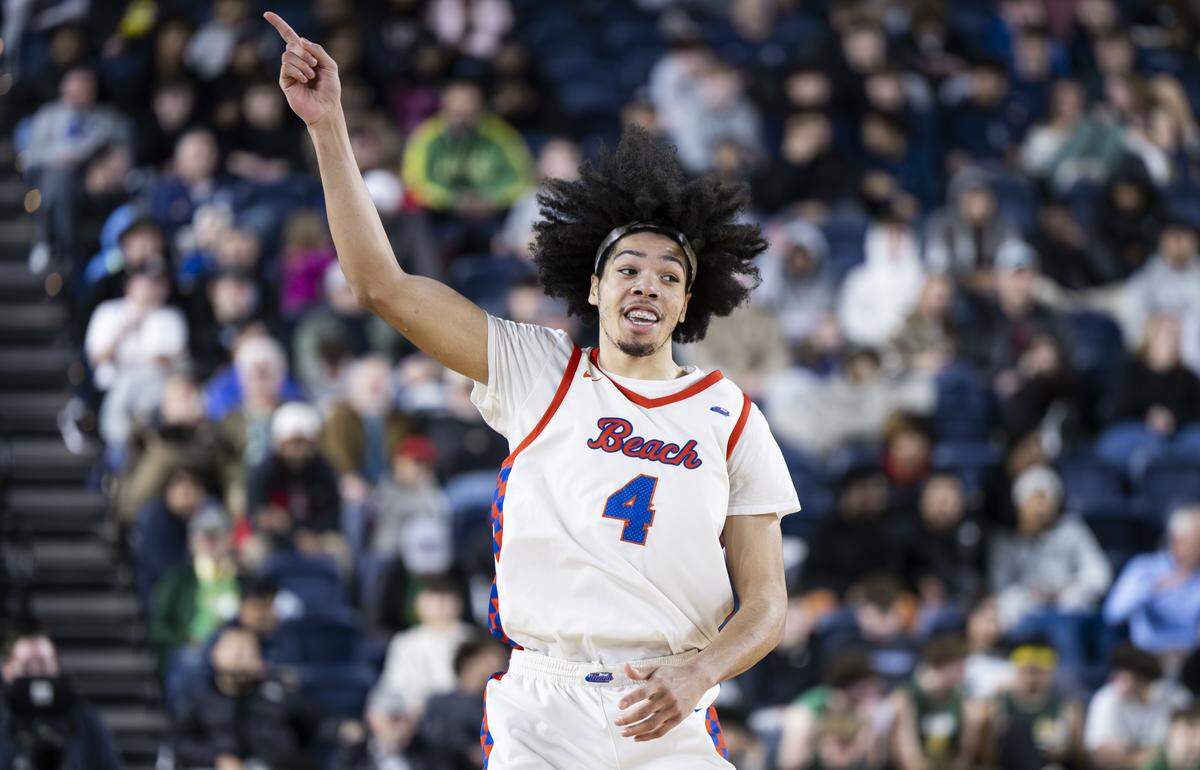 Rainier Beach wing Tyran Stokes (4) reacts to a three point basket against Bellarmine Prep during the semifinal round of the 3A State Tournament at the Tacoma Dome, on Friday, March 6, 2026, in Tacoma.