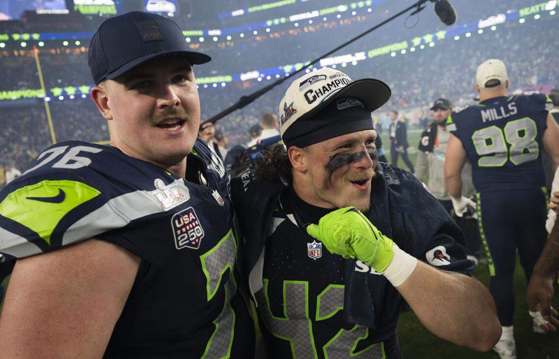 Seattle Seahawks guard Grey Zabel (76) and linebacker Drake Thomas (42) hug after beating the New England Patriots 29-13 in Super Bowl LX at Levi's Stadium on Sunday, Feb. 8, 2026, in Santa Clara, Calif.